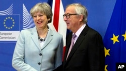 British Prime Minister Theresa May is greeted by European Commission President Jean-Claude Juncker before a meeting at EU headquarters in Brussels, Dec. 8, 2017. May and Juncker met early Friday morning following crucial overnight talks on the issue of the Irish border.
