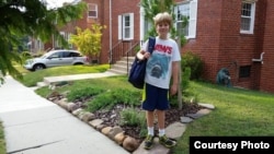 Back-to-school pictures are a tradition. Felix, a 9-year-old boy, starts his first day of 5th grade at a Chinese immersion school in Washington, D.C.