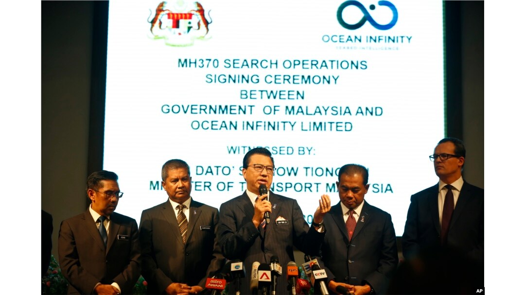 FILE - Malaysian Minister of Transport Liow Tiong Lai, center, speaks at a press conference during MH370 missing plane search operations signing ceremony between the government of Malaysia and the Ocean Infinity Limited in Putrajaya, Malaysia, Jan. 10, 2018.