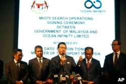 FILE - Malaysian Minister of Transport Liow Tiong Lai, center, speaks at a press conference during MH370 missing plane search operations signing ceremony between the government of Malaysia and the Ocean Infinity Limited in Putrajaya, Malaysia, Jan. 10, 2018.