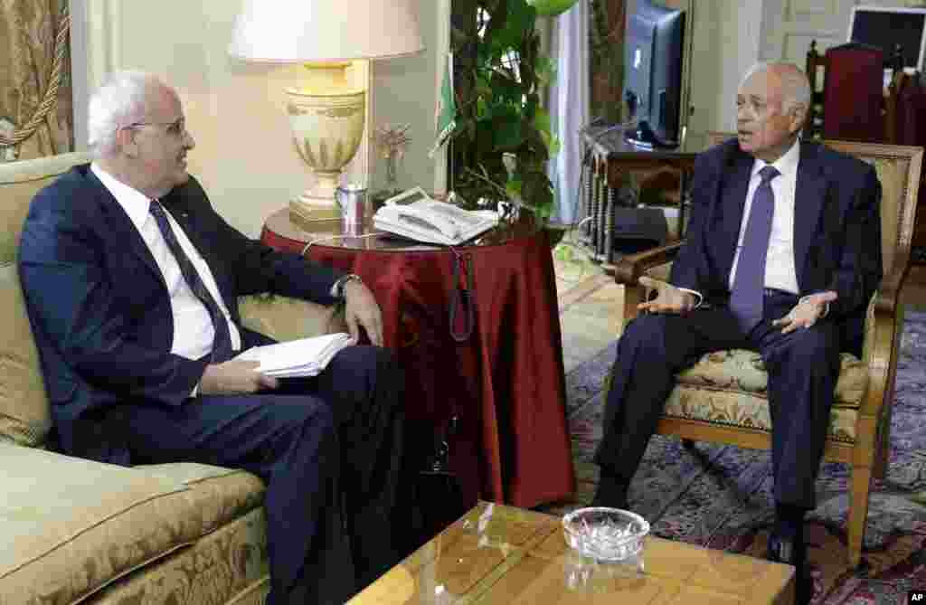 Arab League Secretary General Nabil Elaraby, right, meets with chief Palestinian negotiator Saeb Erekat, in Cairo, Egypt, Monday, Aug. 11, 2014.