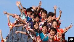 Kimono-clad women who celebrate turning 20 years old react as they ride a roller coaster following a coming of age ceremony at Toshimaen amusement park on Coming of Age Day national holiday in Tokyo, Jan. 9, 2017.