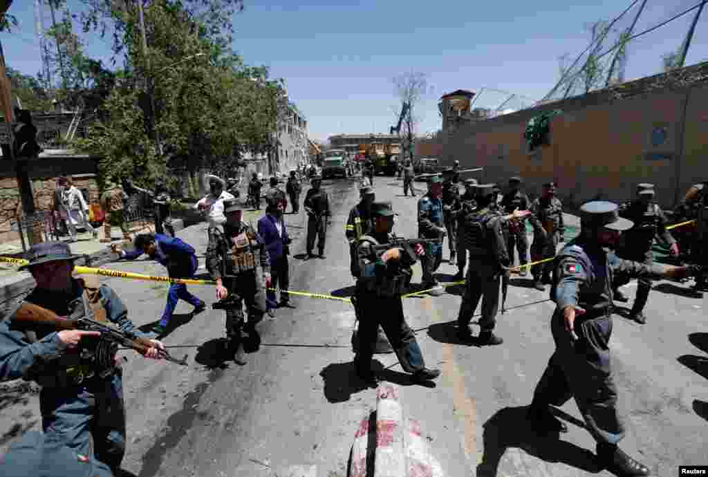 Afghan policemen inspect the site of a blast in Kabul, Afghanistan May 31, 2017. 