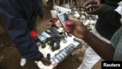 A vendor hawks second-hand mobile phones at the sprawling Kibera slum, one of the largest and poorest slums in Africa, near Kenya's capital Nairobi, August 26, 2011. 