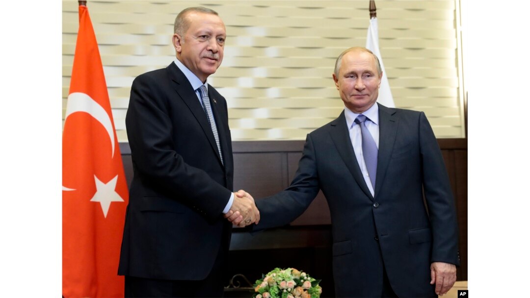 Russian President Vladimir Putin, right, and Turkish President Recep Tayyip Erdogan pose for a photo during their meeting in the Bocharov Ruchei residence in the Black Sea resort of Sochi, Russia, Tuesday, Oct. 22, 2019.