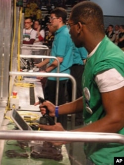 Students at the controls, trying to get their robots to kick a soccer goal.