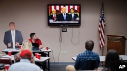 Supporters watch President Donald Trump speak at a State of the Union watch party hosted by the Hamilton County Republican Party, Jan. 30, 2018, in Cincinnati.