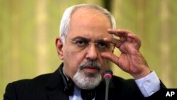 Iranian Foreign Minister Mohammad Javad Zarif adjusts glasses during joint press conference with Italian counterpart Emma Bonino, Tehran, Dec. 22, 2013.