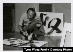 Tyrus Wong works on a calligraphic painting at his studio.