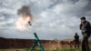 FILE - Syrian rebels fire a mortar towards regime forces stationed at Kwiriss airport in Al-Bab, 30 kilometers from the northeastern Syrian city of Aleppo, February 14, 2013. 
