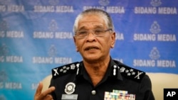 Malaysian police Deputy Inspector Gen. Noor Rashid Ibrahim gestures as he speaks during a press conference at the police headquarters in Kuala Lumpur, Malaysia Wednesday, Sept. 23, 2015. 