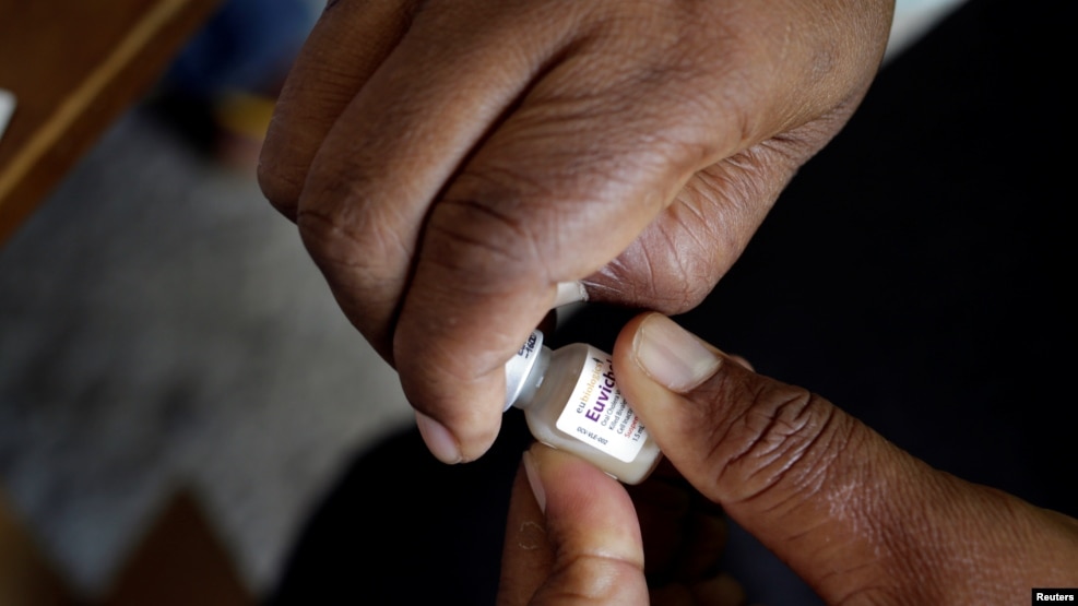 FILE - A member of the vaccination campaign against cholera opens a vial at the Immaculate Conception Hospital in Les Cayes, Haiti, Nov. 8, 2016. 