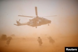 FILE - A military helicopter takes off during the regional anti-insurgent Operation Barkhane in Inaloglog, Mali, Oct. 17, 2017.