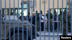 Israeli troops gather at the scene of what an Israeli police spokeswoman said was a car-ramming attempt by a Palestinian at the West Bank checkpoint of Qalandia, near Ramallah, Dec. 18, 2015. 