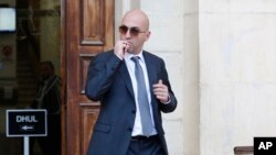 FILE - In this Nov. 29. 2019 file photo, Maltese businessman Yorgen Fenech, leaves court after being questioned in the 2017 bomb blast that killed investigative journalist Daphne Caruana Galizia as she drove near her home, in Valletta, Malta.