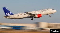 FILE - A Scandanavian Airlines, known as SAS, Airbus A320-200 airplane takes off from the airport in Palma de Mallorca, Spain.
