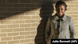 Joycelyn Davis, a direct descendant of slave ship Clotilda survivor Charlie Lewis, stands for a portrait at the community center in Africatown in Mobile, Ala.