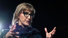 Bosnian filmmaker Jasmila Zbanic speaks and gestures during an interview with the Associated Press in the capital Sarajevo, Bosnia, Saturday, Jan. 30, 2021. (AP Photo/Kemal Softic)