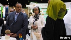 Mswati III, King of Swaziland (L) tours the exhibition hall during the first day of the World Energy Forum at the Dubai World Trade Centre, Oct. 22, 2012. 