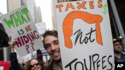 Demonstrators participate in a march and rally to demand President Donald Trump release his tax returns in New York, April 15, 2017.