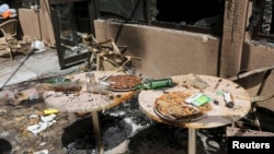 Pizzas are seen on the terrace of Cappuccino restaurant after an attack on the restaurant and the Splendid Hotel in Ouagadougou, Burkina Faso, Jan. 18, 2016.