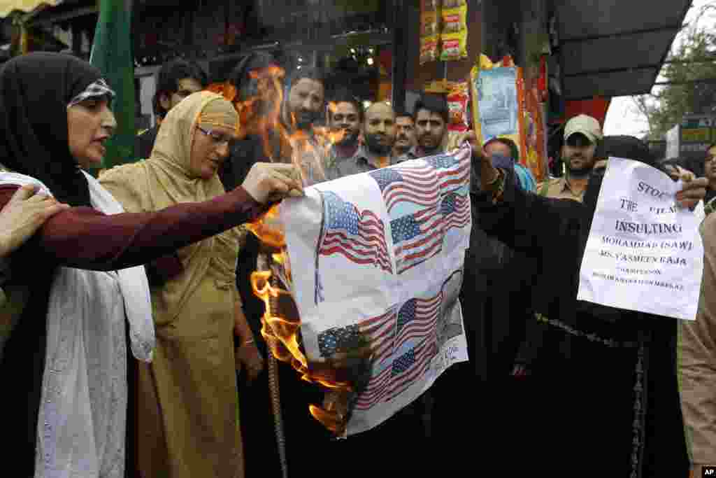 Activists of Muslim Khawateen Markaz, or Muslim Women's Center, burn a mock American flag during a protest in Srinagar, India, Sept. 17, 2012.