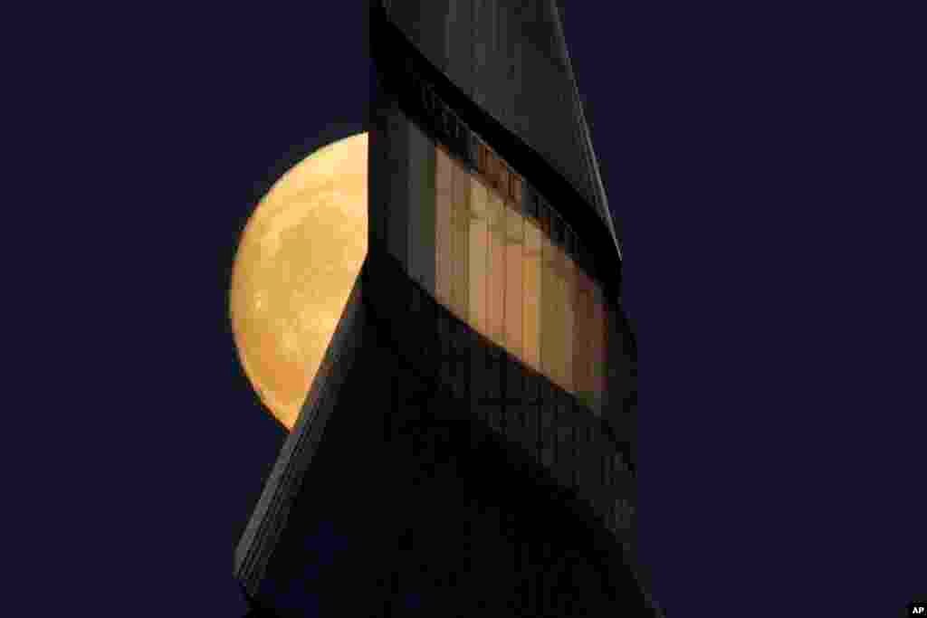 The waxing moon rises behind the 91-meter-tall spire at the Community of Christ temple, Sept. 19, 2021, in Independence, Missouri.