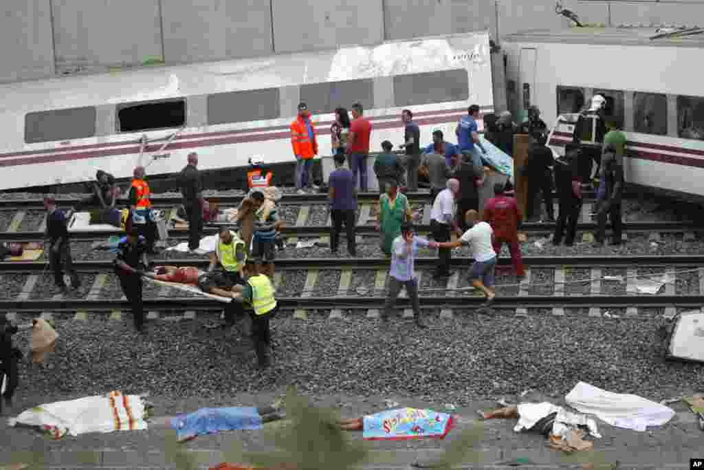 Emergency personnel at the scene of a train derailment in Santiago de Compostela, Spain, July 24, 2013. 