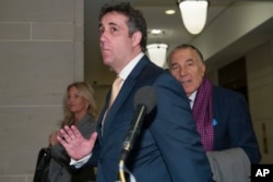 FILE - Michael Cohen, center, President Donald Trump's former lawyer, arrives to testify before a closed-door hearing of the House Intelligence Committee accompanied by his lawyer, Michael Monico, on Capitol Hill, Feb. 28, 2019, in Washington.