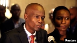 Jovenel Moise addresses the media next to his wife, Martine, after winning the November 20 presidential election in Port-au-Prince, Haiti, Nov. 28, 2016.