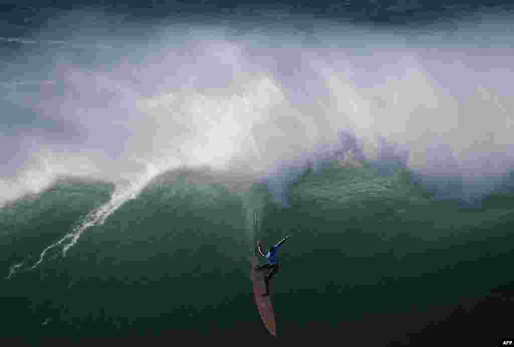 American big wave surfer Nic Lamb drops a wave off Praia do Norte in Nazare during the first edition of the World Surf League&#39;s Nazare Challenge, Portugal.
