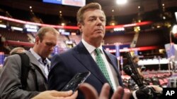 FILE - Paul Manafort talks to reporters on the floor of the Republican National Convention at Quicken Loans Arena in Cleveland.
