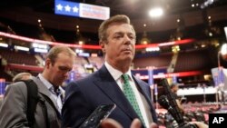FILE - Paul Manafort talks to reporters on the floor of the Republican National Convention at Quicken Loans Arena in Cleveland.