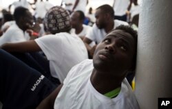 FILE-An African migrant rests after being rescued in a rescue operation, on the Aquarius vessel of SOS Mediterranee NGO and MSF (Doctors Without Borders) in the international waters some 25 Nautical miles (29 miles, 46 kilometers) north of the Libyan coas