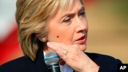 Democratic presidential candidate Hillary Rodham Clinton brushes off a lady bug that landed on her as she speaks Wednesday, Oct. 7, 2015, during a campaign stop at the Westfair Amphitheater in Council Bluffs, Iowa.