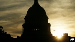 FILE - The sun rises over the U.S. Capitol in Washington, Sept. 24, 2013. 