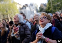 People attend the Chrism Mass, as part of the Holy Week, at the Saint Sulpice Church in Paris, France, April 17, 2019.
