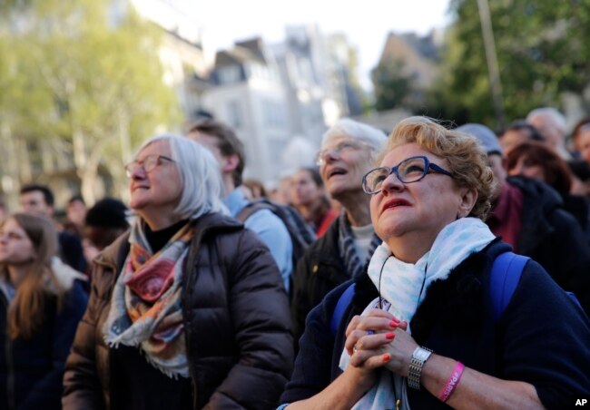 People attend the Chrism Mass, as part of the Holy Week, at the Saint Sulpice Church in Paris, France, April 17, 2019.