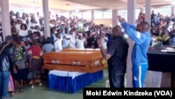 Mourners gather for Nancy Azah and her husband, Njong Padisco, both nurses killed in Cameroon's northwest region, during their funeral services in Alahkuma, Aug. 15, 2018.