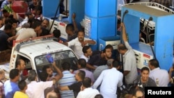 People argue at a petrol station during a fuel shortage in Cairo, June 26, 2013.