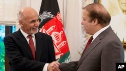 Pakistan's Prime Minister Nawaz Sharif, right, receives Afghan President Ashraf Ghani at the prime minister house in Islamabad, Pakistan, Saturday, Nov. 15, 2014.