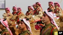 An honor guard on camelback greets Saudi Arabia's King Salman, not seen, in a lavish welcome ceremony complete with cannon salutes, in Amman, Jordan, March 27, 2017. Salman is in Jordan to attend the annual Arab Summit, to be held March 29.