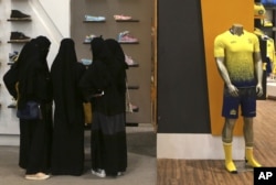 FILE - Saudi women shop at a mall in Riyadh, Dec. 11, 2015.
