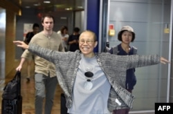 Liu Xia, the widow of Chinese Nobel dissident Liu Xiaobo, smiles as she arrives at the Helsinki International Airport in Vantaa, Finland, July 10, 2018.