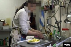 A sreengrab from video shows a woman working in the kitchen of the Kitezh Women’s Crisis Center in Moscow. Russian official figures show 40 percent of violent crimes are committed within the family and thousands of women are killed every year as a result of domestic violence.