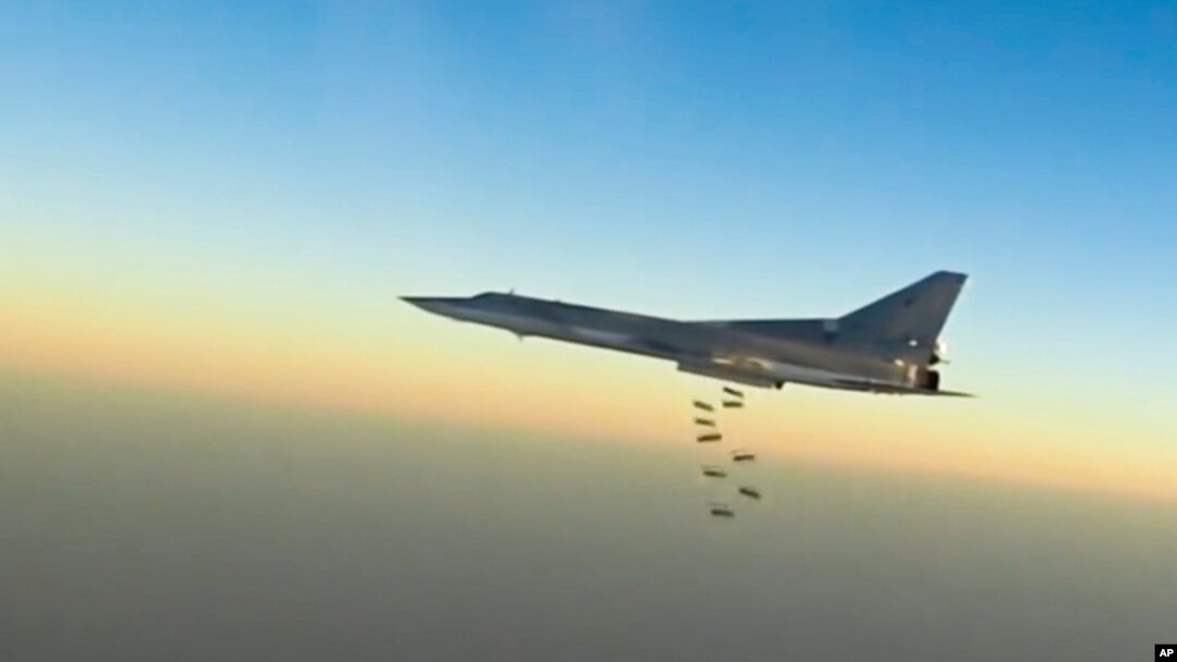 In this frame grab from video provided by the Russian Defence Ministry Press Service, Russian long-range bomber Tu-22M3 flies during a strike above an undisclosed location in Syria, Aug. 14, 2015.
