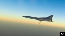 In this frame grab from video provided by the Russian Defence Ministry Press Service, Russian long-range bomber Tu-22M3 flies during a strike above an undisclosed location in Syria, Aug. 14, 2015.