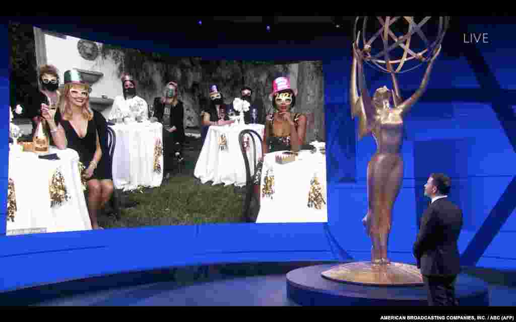 This handout screen shot released courtesy of American Broadcasting Companies, Inc./ABC shows host Jimmy Kimmel in front of a screen showing nominee Kerry Washington (R) and Reese Witherspoon watch remotely the 72nd Primetime Emmy Awards ceremony held virtually, Sept. 20, 2020.