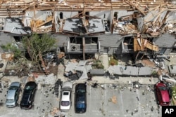 Debris is strewn about the front sidewalks of destroyed homes at the River's Edge apartment complex the day after a tornado struck the city, in Dayton, Ohio, May 28, 2019.