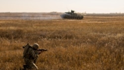 A service member of the Ukrainian armed forces takes part in drills at a training ground near the border with Russian-annexed Crimea in Kherson region, Ukraine, in this handout picture released by the General Staff of the Armed Forces of Ukraine press service, Nov. 17, 2021.